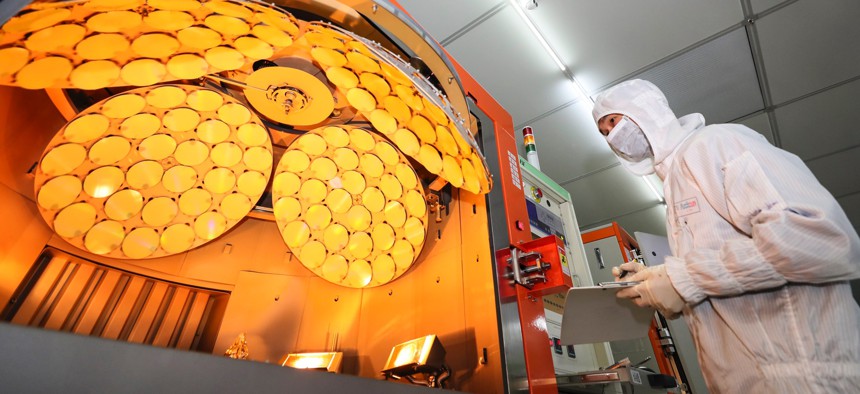 An employee works on the production line of LED epitaxial wafers at a factory of Jiangsu Azure Corporation Cuoda Group Co. in Huaian in China's Jiangsu Province in March 2022. 